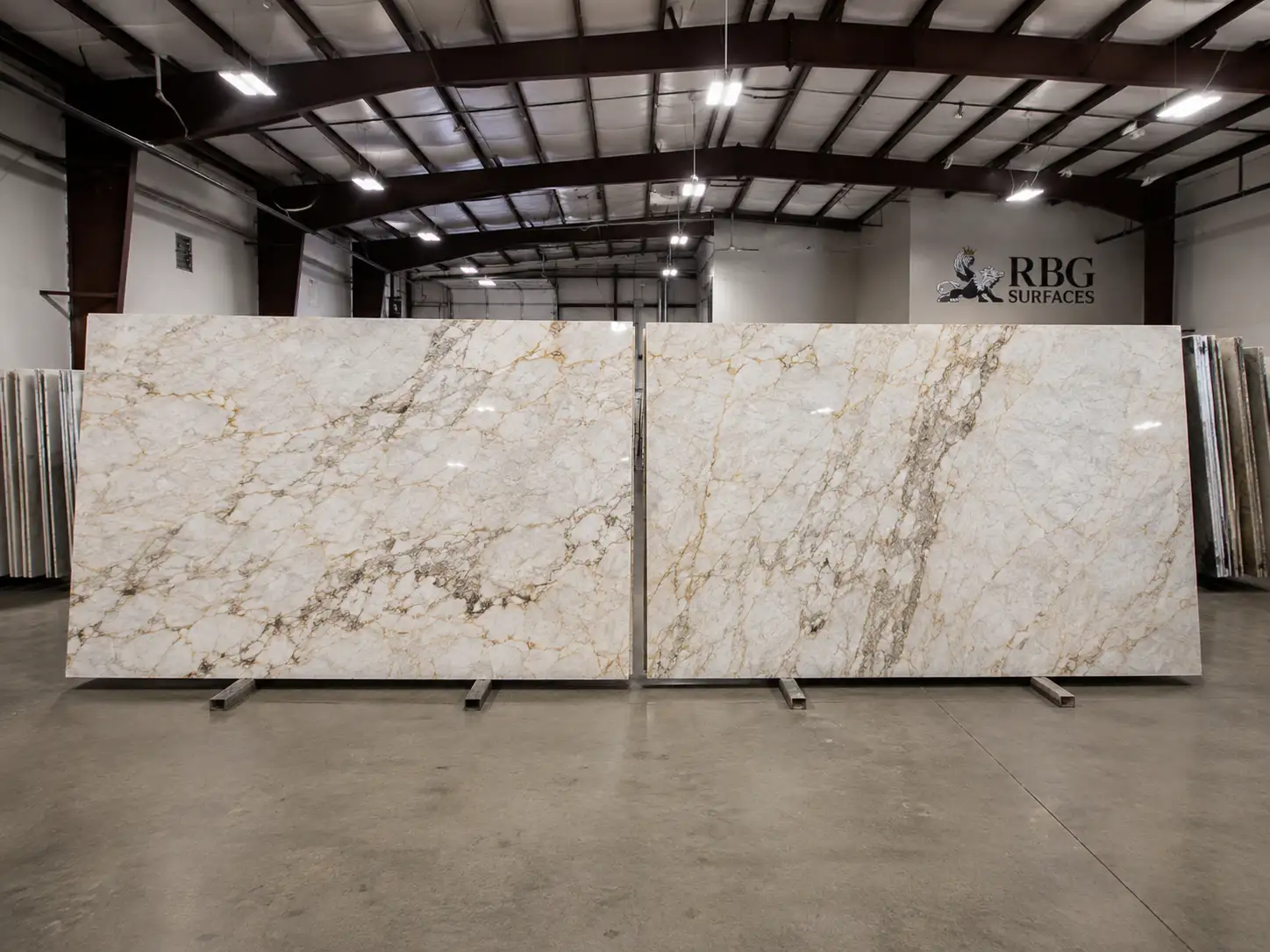 Two coordinating natural stone slabs displayed side by side at RBG Surfaces