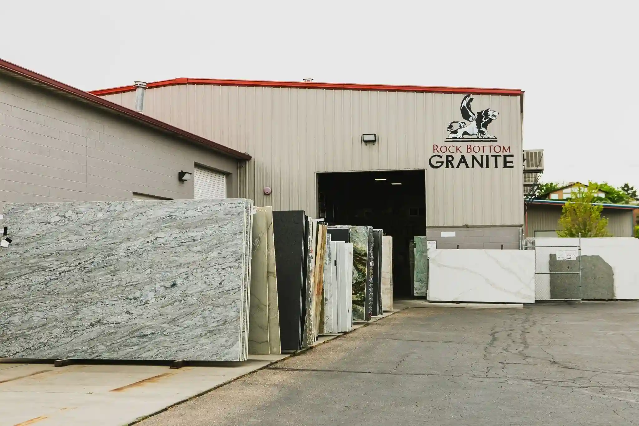 Full-size natural stone slabs displayed outside RBG Surfaces in Garden City