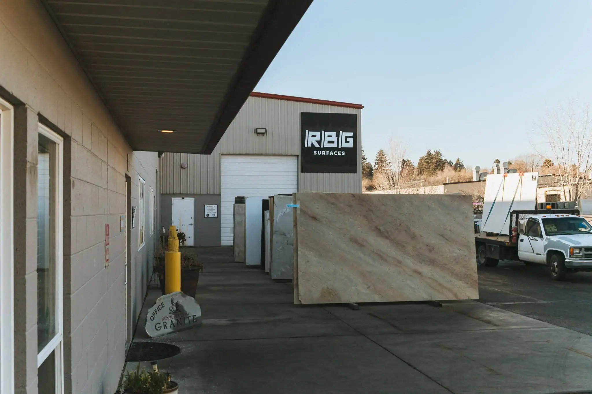 Full-size stone slab displayed outside RBG Surfaces for in-person comparison