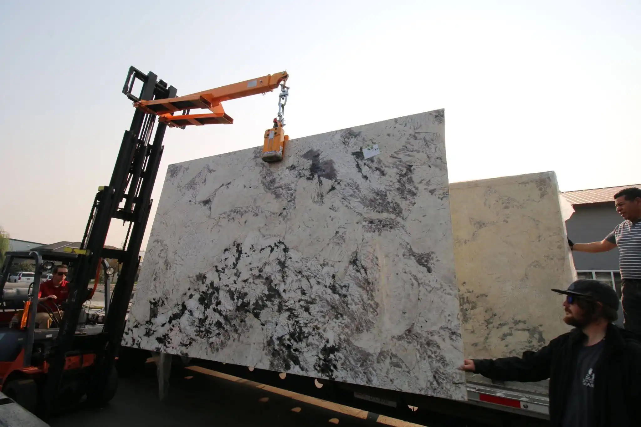 RBG Surfaces team moving natural stone slabs at the slab yard