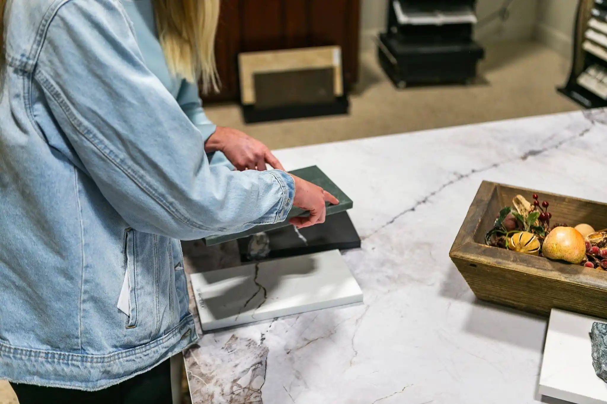 Homeowner comparing countertop samples before selecting a slab