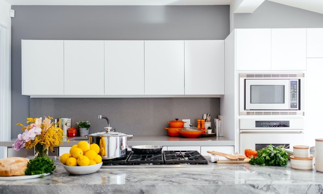 Grey granite countertops in a white kitchen