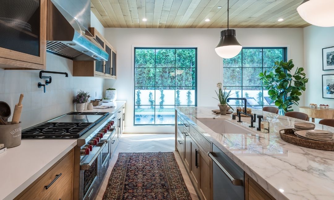 Quartzite island countertop in a white kitchen