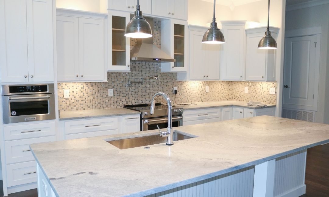 White granite countertops in a white kitchen