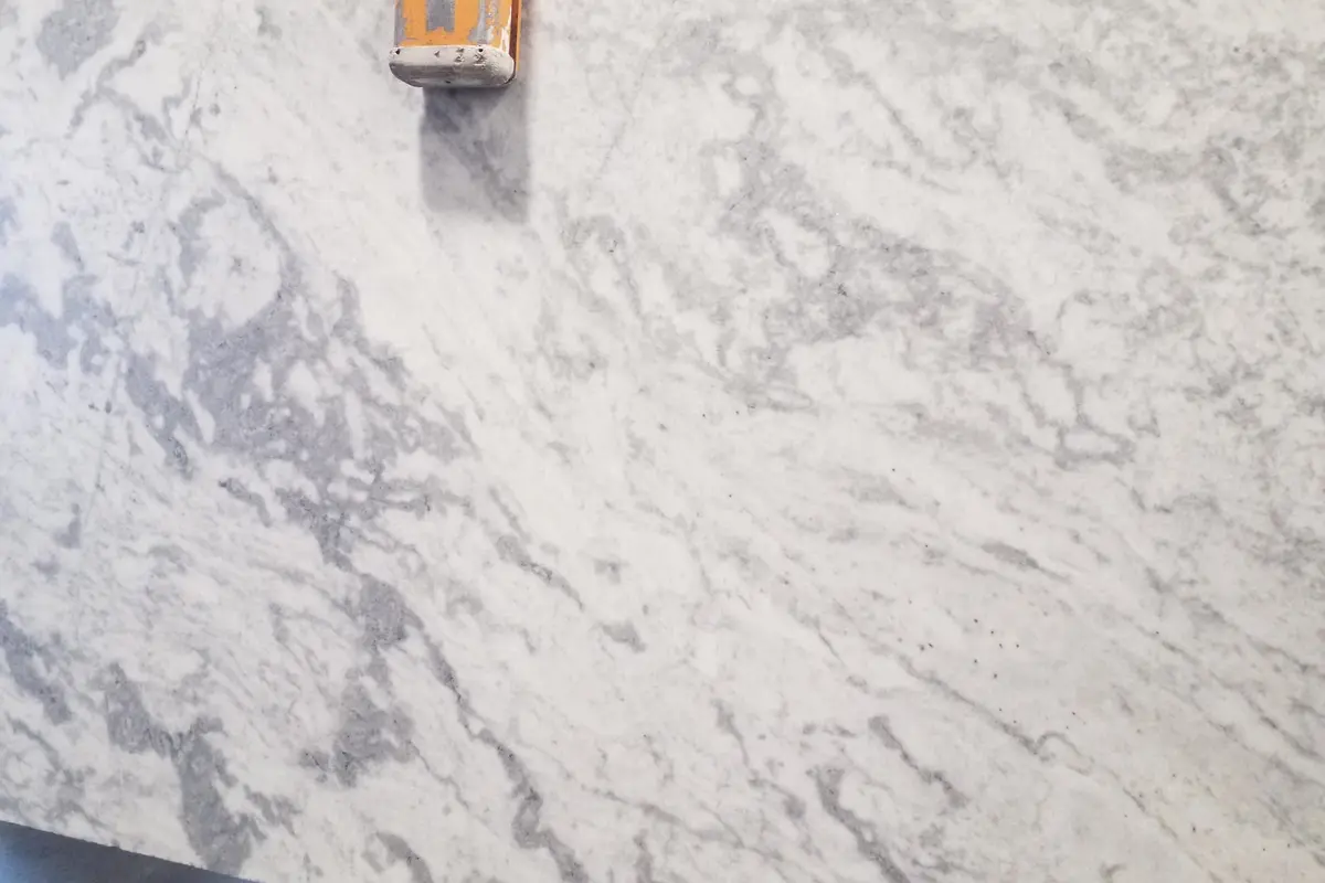 Statuario dual finish marble with clouded gray movement